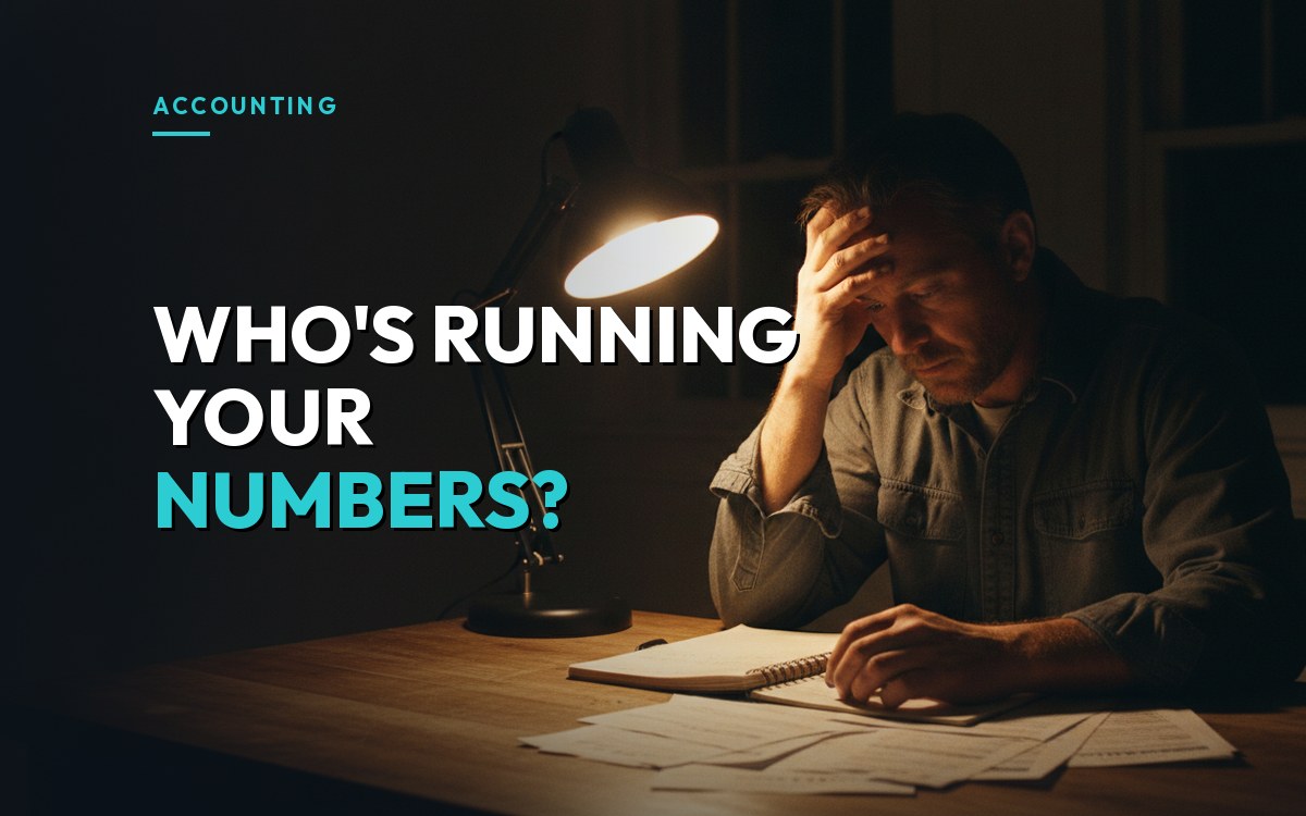 A contractor sits at a kitchen table at night with a ledger and invoices, head in hand, over the headline "Who's running your numbers?"
