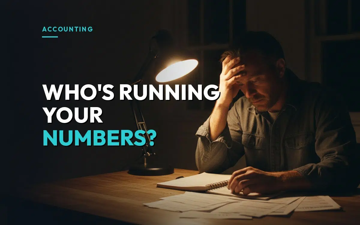 A contractor sits at a kitchen table at night with a ledger and invoices, head in hand, over the headline "Who's running your numbers?"