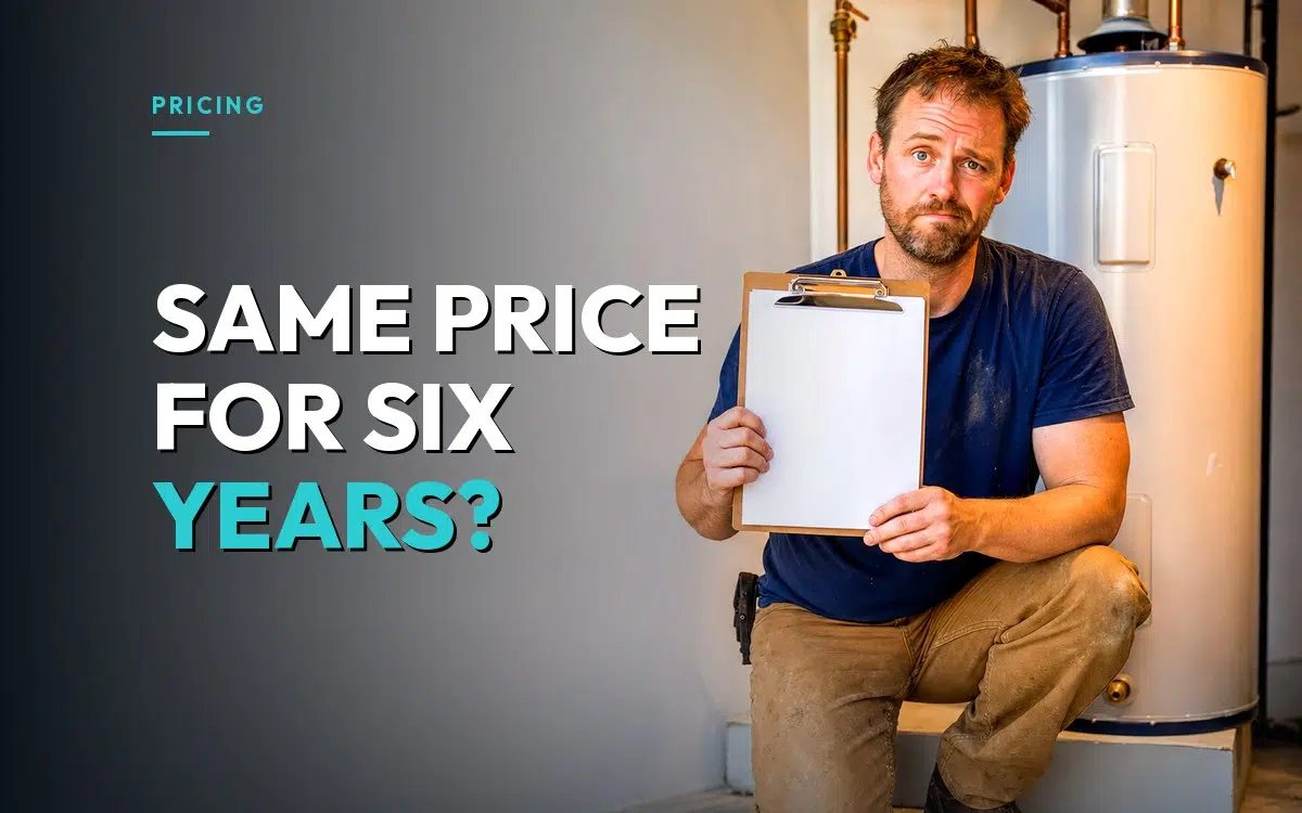 Plumber kneeling beside a new water heater holding an estimate clipboard, hesitant about raising his price